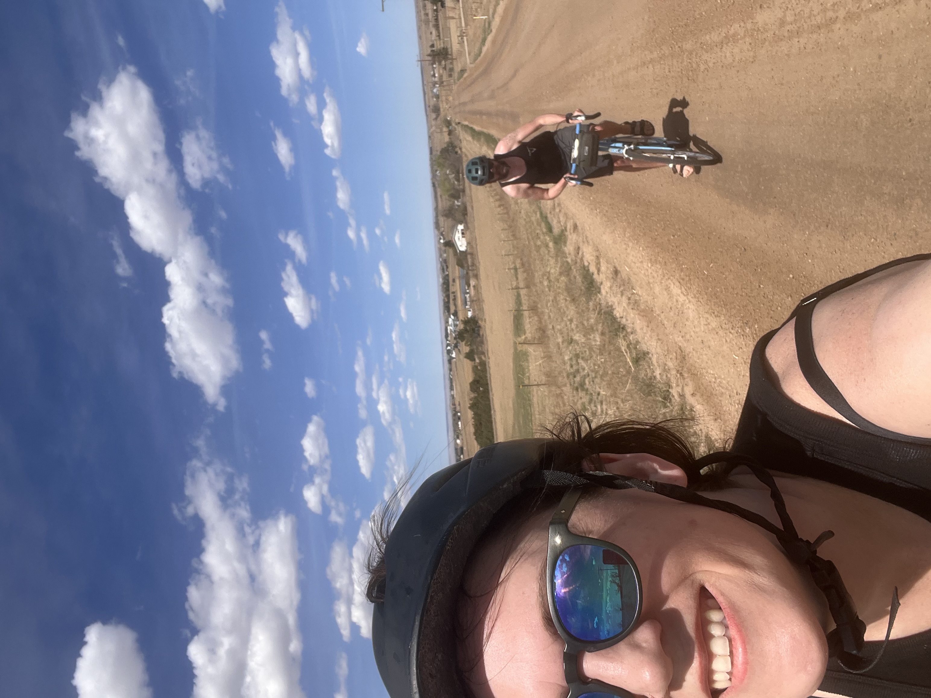 Kristin biking on a gravel road