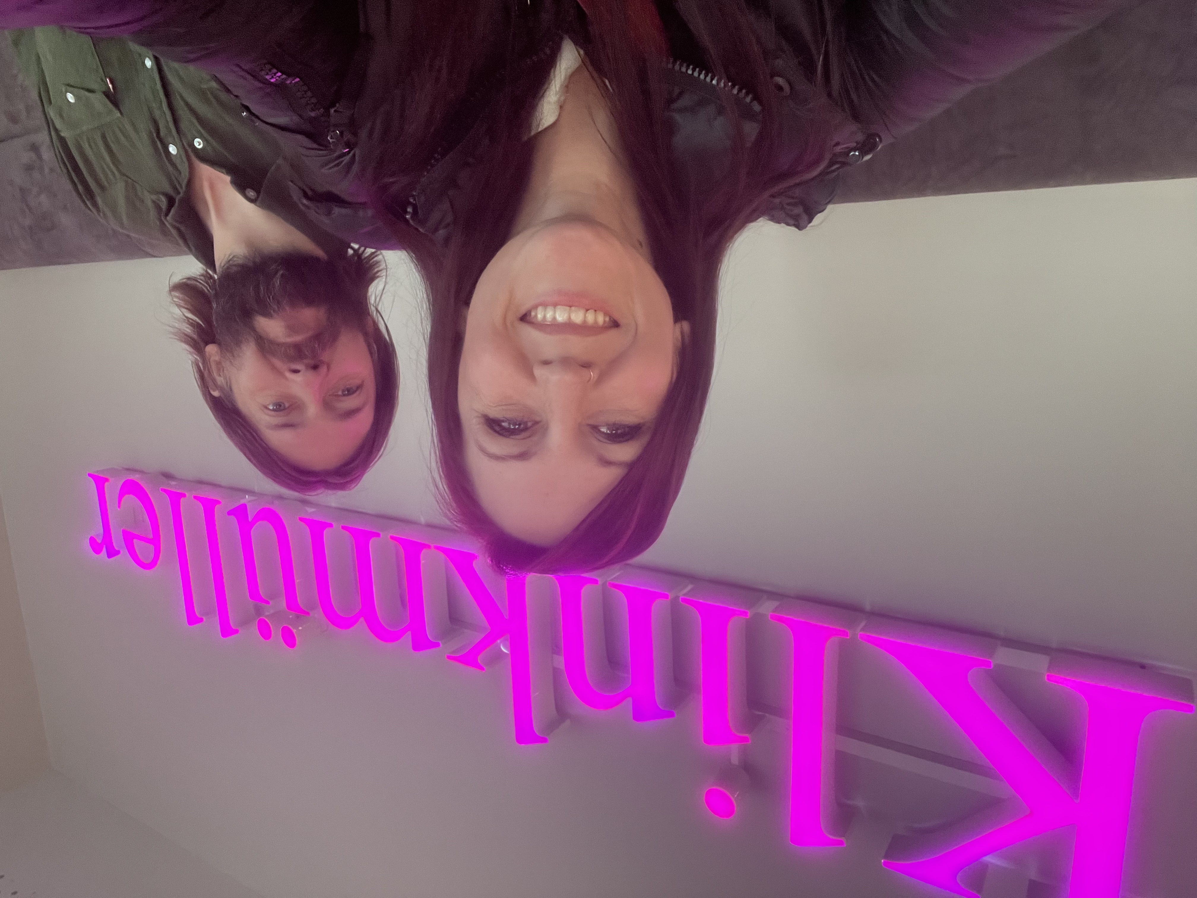 Kristin in front of a neon sign