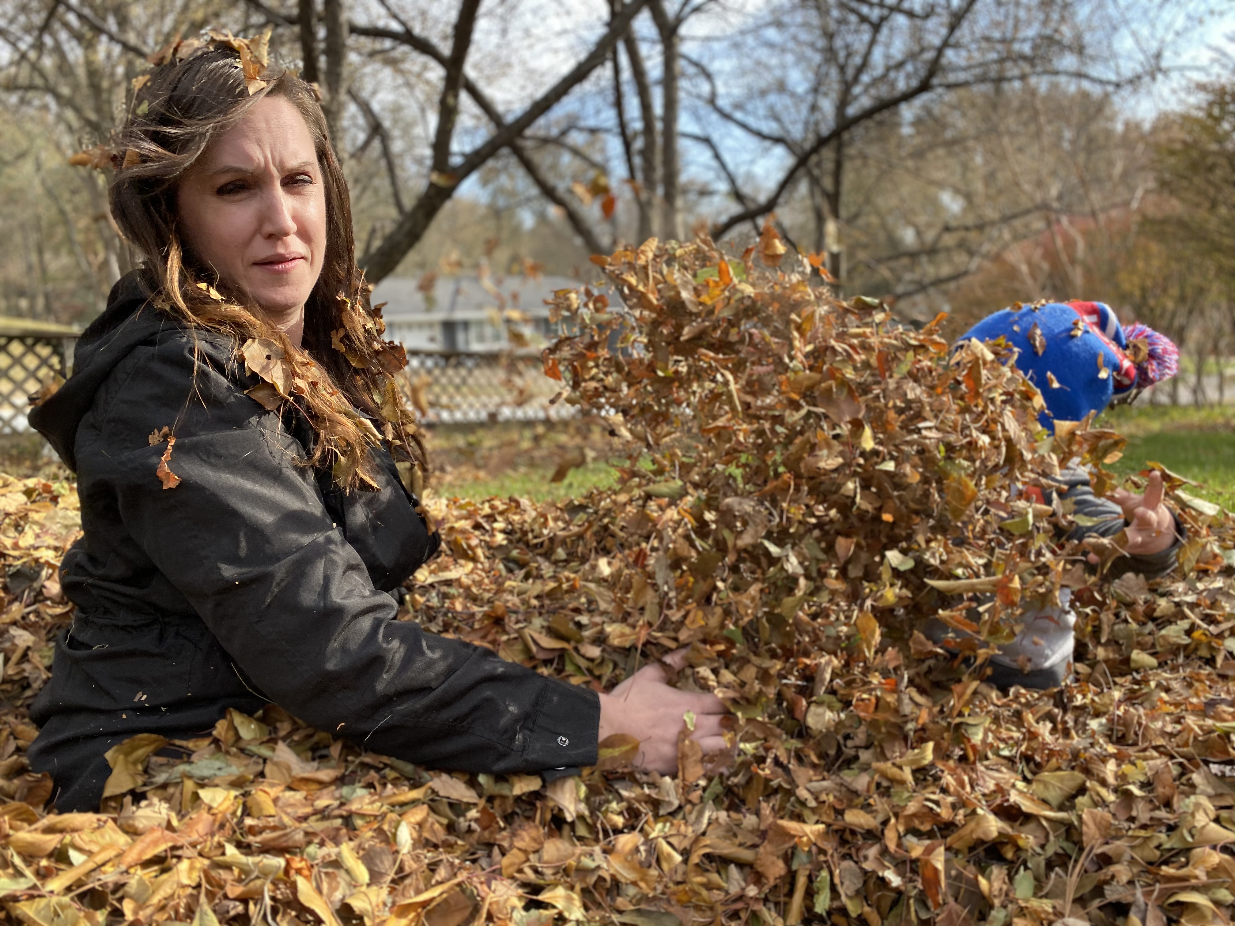 Kristin playing in autumn leaves